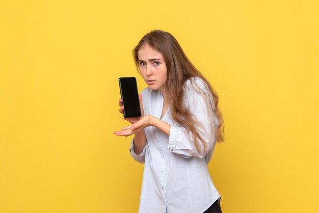 Front view of young woman holding smartphone