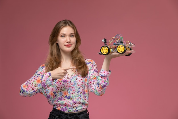 Front view young woman illustrates car toy