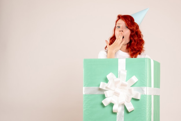 Front view young woman inside present shocked on white background