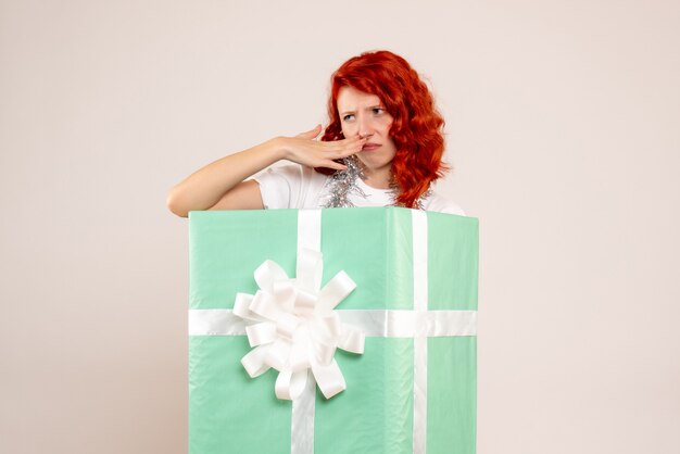 Front view young woman inside present on a white background