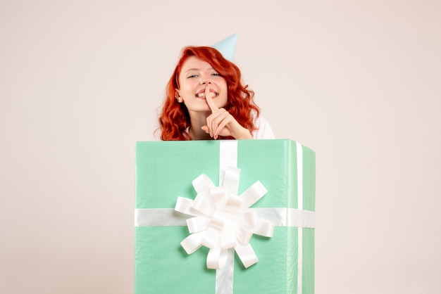 Free photo front view young woman inside present on white background