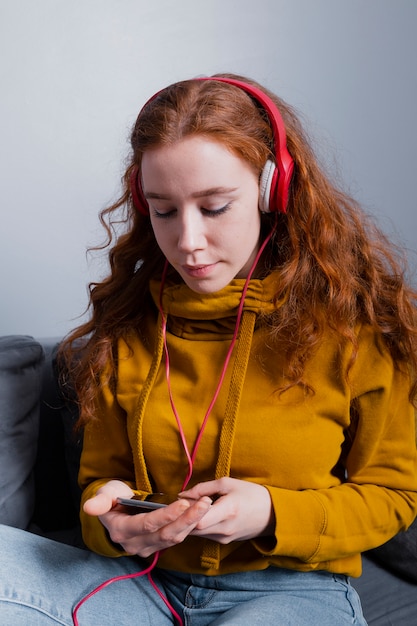 Front view young woman listening music