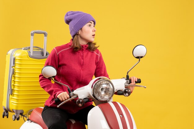 Front view young woman on moped staring at something