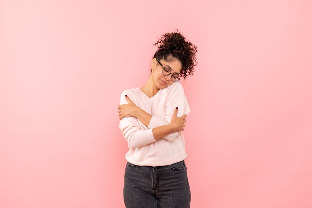 Free photo front view of young woman on pink wall