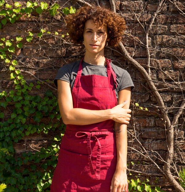 Front view young woman posing in her garden