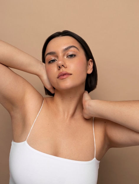 Free photo front view young woman posing in studio