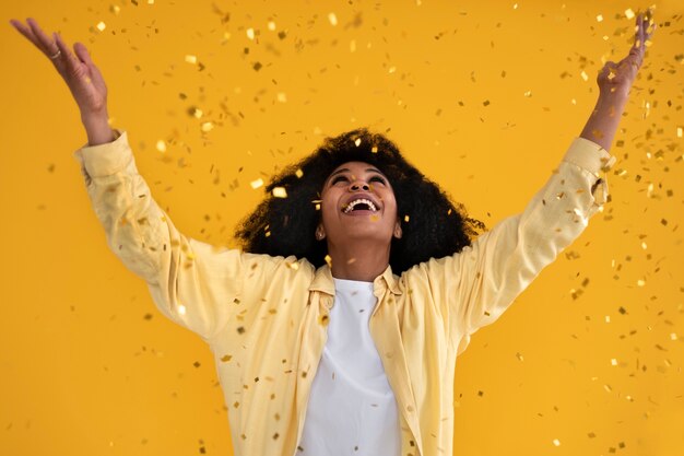 Front view young woman posing with confetti