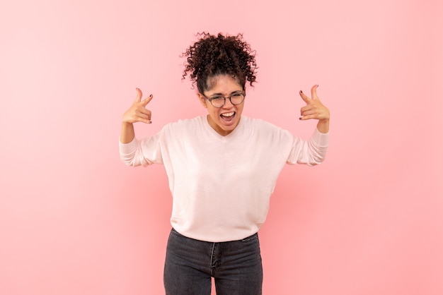 Free photo front view of young woman rejoicing on pink wall