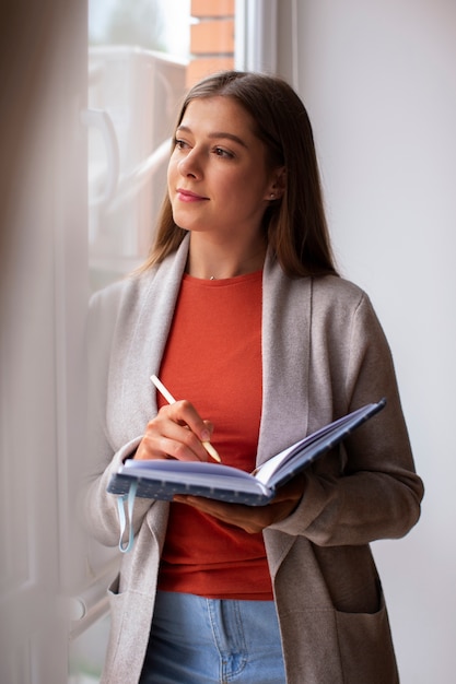 Front view young woman spending time at home