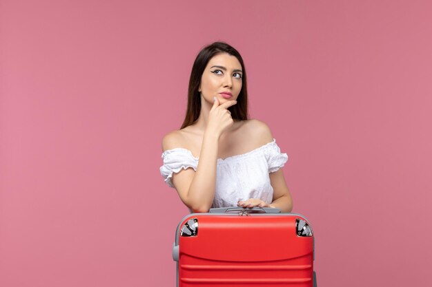 Front view young woman standing and preparing for vacation on light pink background journey sea trip abroad overseas voyage