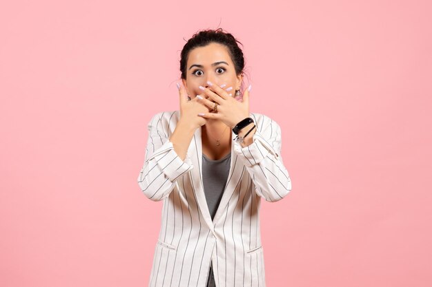 Front view young woman wearing white jacket with shocked face on pink background lady fashion color woman emotion