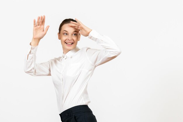 Front view young woman in white blouse with excited expression on the white background female model office emotion job feeling