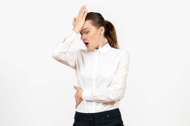 Front view young woman in white blouse with shocked face on white background office job female emotions feelings model