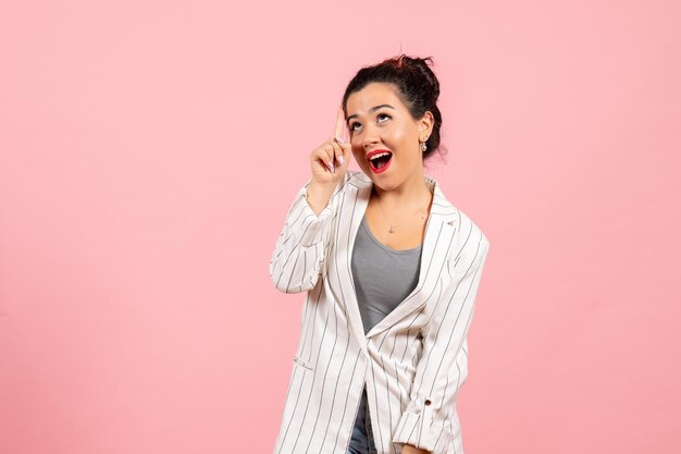 Front view young woman in white jacket posing on light pink background lady fashion color woman emotion