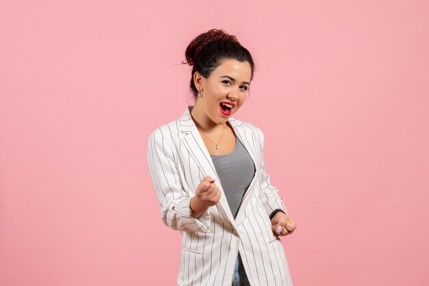 Front view young woman in white jacket posing on pink background lady fashion color woman emotion