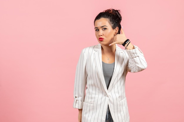 Front view young woman in white jacket posing on pink background lady fashion colors woman emotion