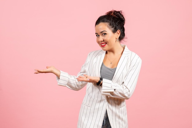 Front view young woman in white jacket posing with smile on pink background lady fashion color woman emotion