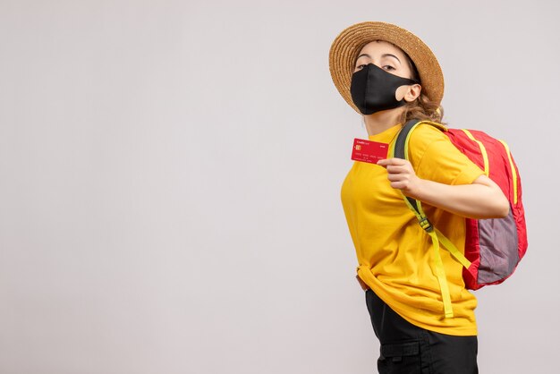 Front view young woman with black mask holding up card