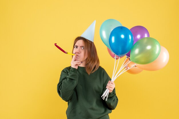 Front view young woman with colorful balloons