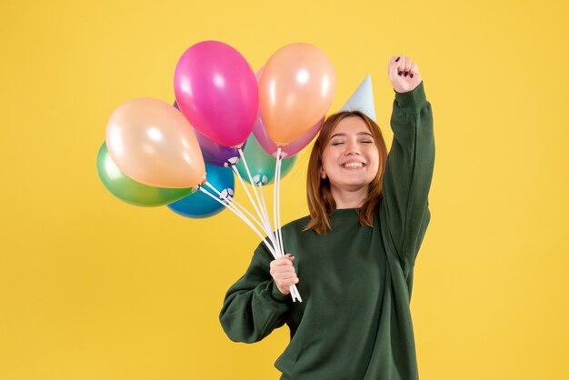 Front view young woman with colorful balloons