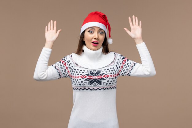 Front view young woman with excited expression on brown background christmas emotion new year