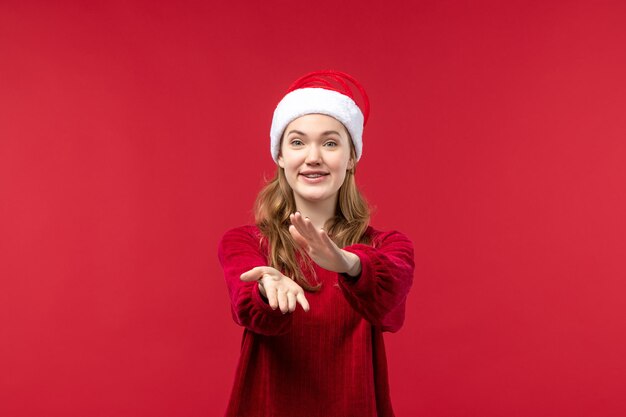 Front view young woman with excited expression clapping, christmas holiday red