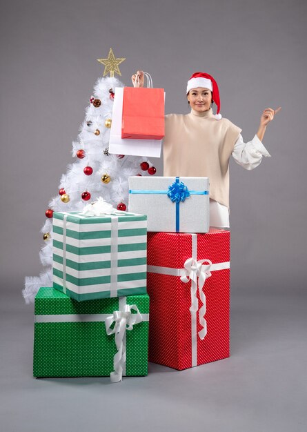 Front view young woman with holiday presents on the light