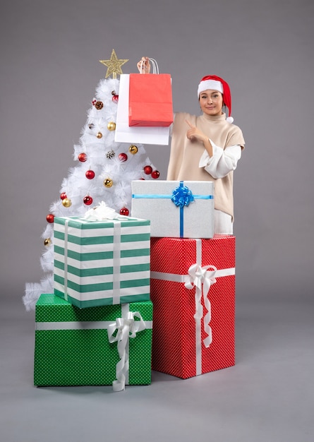 Front view young woman with holiday presents on the light