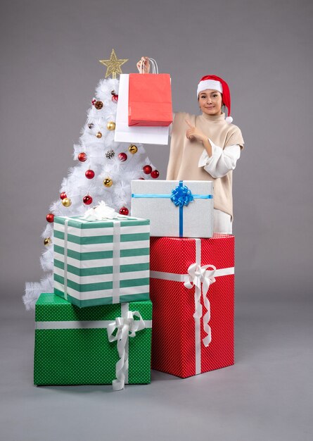 Front view young woman with holiday presents on the light