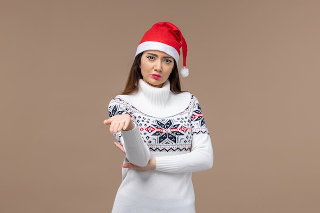 Front view young woman with mad expression on brown background christmas emotion new year