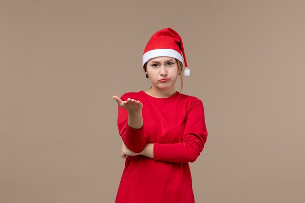 Front view of young woman with mad face on brown