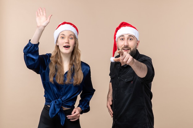 Free photo front view of young woman with man expressing different emotions on pink wall