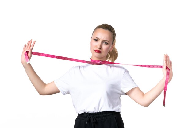 Front view young woman with measure tape around her throat on white background losing skin measuring slimming beauty torso hip body