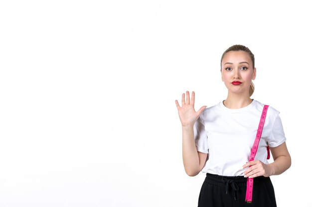 Front view young woman with measure tape on white surface