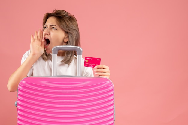 Front view young woman with pink suitcase holding map shouting