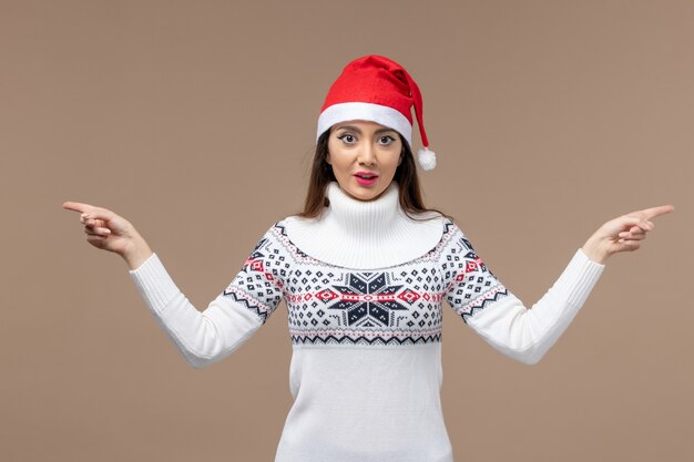 Front view young woman with red christmas cap on brown background christmas new year emotion