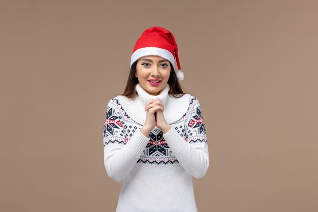 Front view young woman with smiling expression on brown background christmas new year emotion