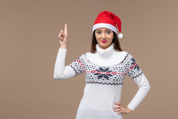 Front view young woman with smiling expression on brown background new year emotion christmas