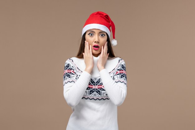 Front view young woman with surprised expression on brown desk christmas emotion new year