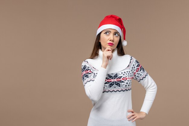 Front view young woman with thinking expression on brown background new year emotion christmas