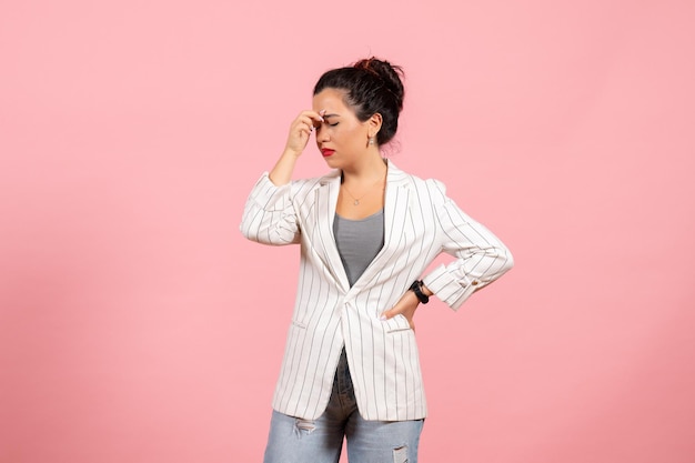 Front view young woman with white jacket having headache on pink background lady fashion woman emotions color