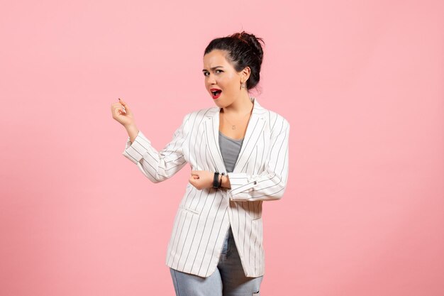 Front view young woman with white jacket posing on pink background lady fashion woman emotions color