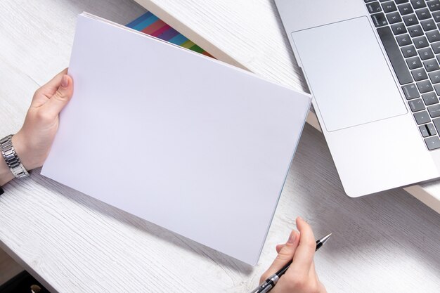 A front view young woman working with empty blanks in front of table with laptops job activity business