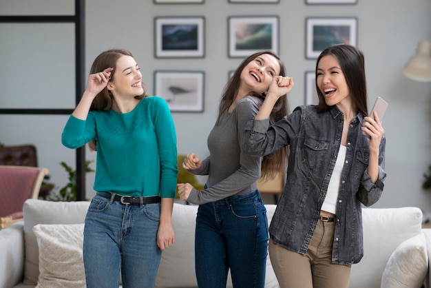 Front view young women happy together at home