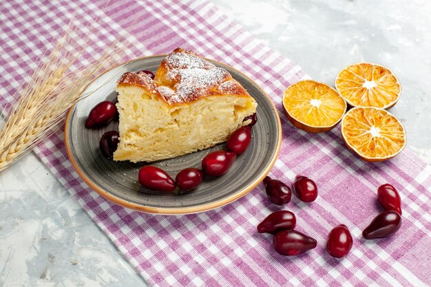 Front view yummy cake slice with fresh red dogwoods on white surface fruit berry biscuit sugar cake pie