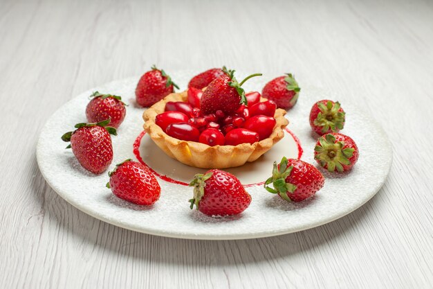 Front view yummy cake with fresh fruits inside plate on white desk fruit cake dessert