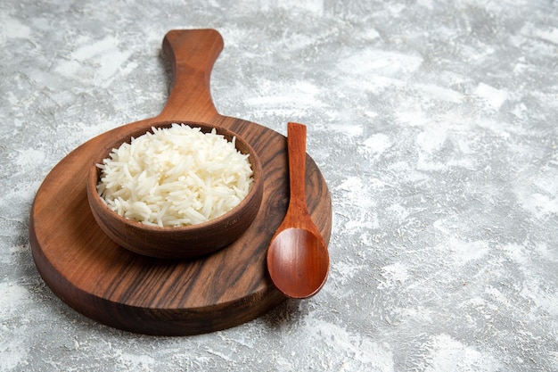 Front view yummy cooked rice inside brown plate on white space