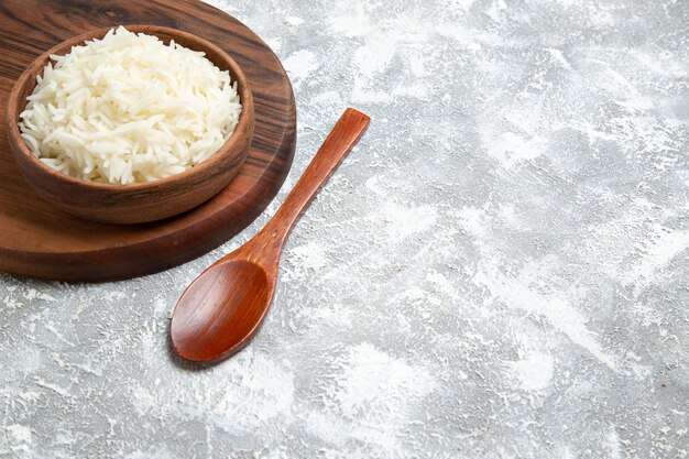 Front view yummy cooked rice inside plate on the white space