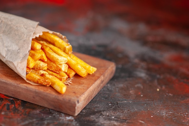 Front view yummy french fries on cutting board dark background dish fast-food sandwich toast snack dinner