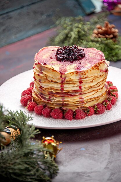 Front view yummy jelly pancakes with fresh strawberries on the dark space